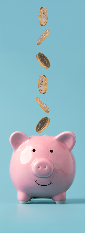 Coins falling into piggy bank