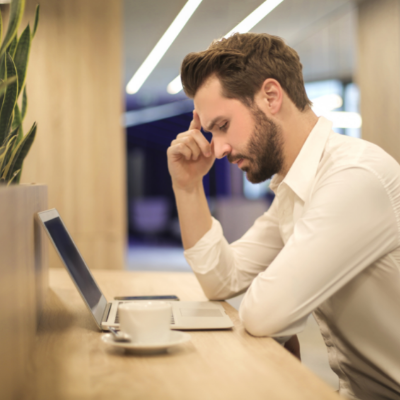 a man looking stressed sitting at his computer