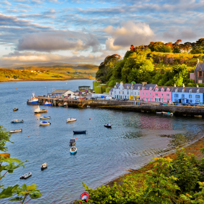 beautiful houses beside a lake at sunset in Scotland