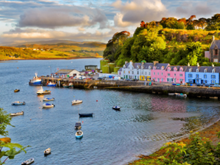 beautiful houses beside a lake at sunset in Scotland