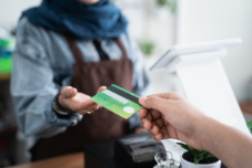 a person handing over their credit card