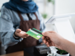 a person handing over their credit card
