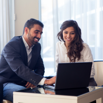 Two people looking at a laptop screen
