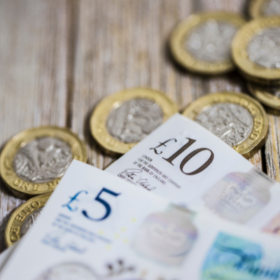 A pile of pound coins and bank notes
