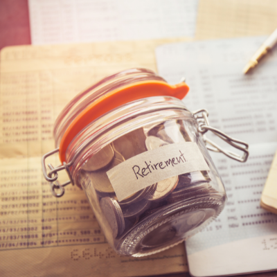 Jar of coins labelled retirement on paperwork