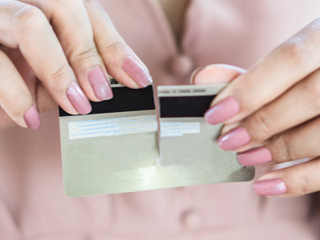 a person ripping up their card