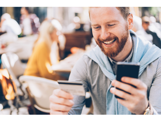 Person using credit card and phone
