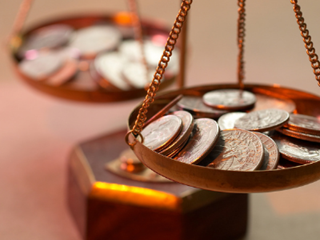 coins on a balancing scale