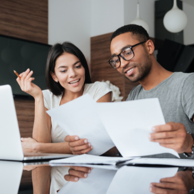 a young couple having a discussion while looking at paperwork
