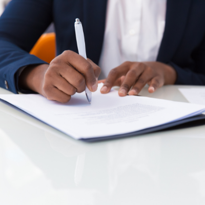 man in suit signing a document