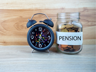 pension coin jar beside alarm clock