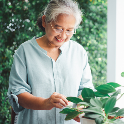 Woman tending to a plant