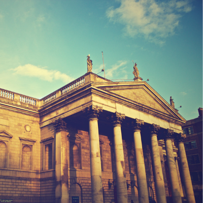 photo of an old bank with a blue sky behind it
