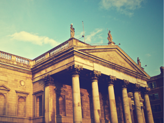 photo of an old bank with a blue sky behind it