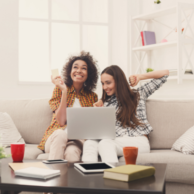 a young couple of girls completing a credit card application on the computer