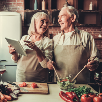 elderly couple cooking together