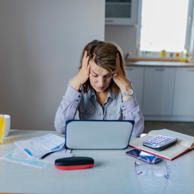 stressed woman looking at her laptop