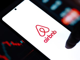 a phone with the application air bnb on the screen