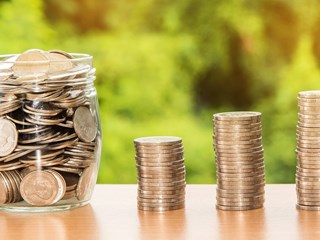 jar of coins and coin stacks