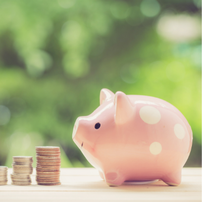 Piggy bank with stack of coins beside it