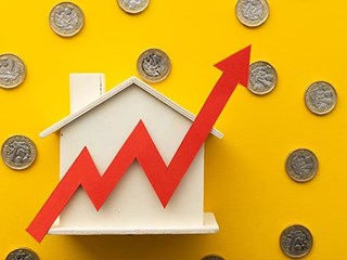 Wooden house surrounded by pound coins and upwards arrow.