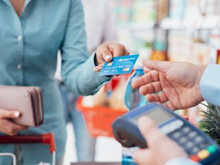 a person handing over their bank card to someone else