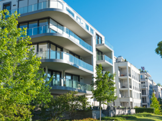 Block of flats overlooking trees and grass