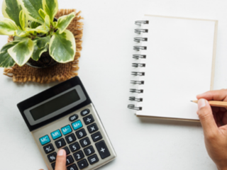 Person using calculator and notebook