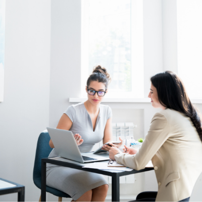 Two women having a meeting with a laptop