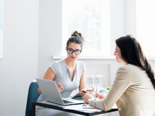 Two women having a meeting with a laptop