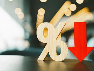 An image of a wooden percentage mark next to a downwards facing arrow.