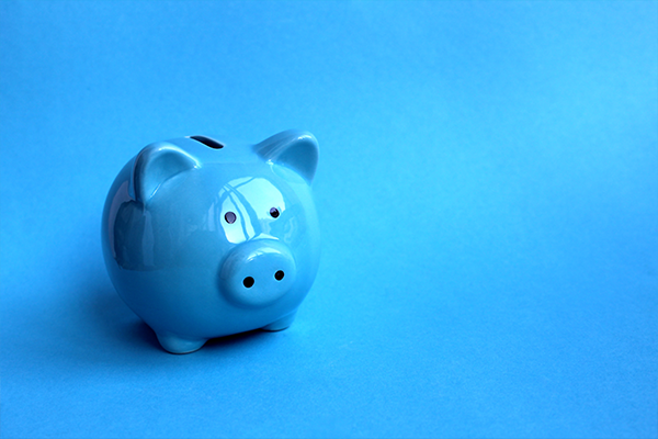 Blue piggy bank against a blue background